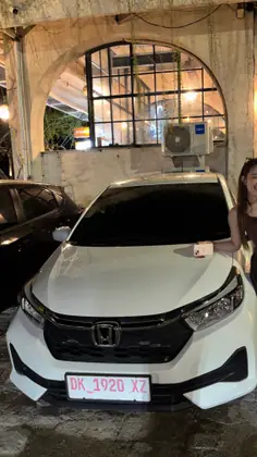 A customer with our white Honda Brio in the evening