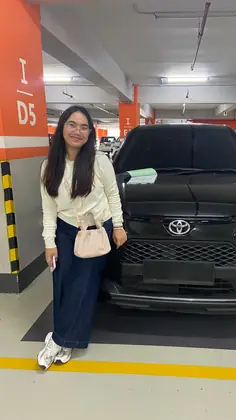 A customer with a black Toyota in a covered car park